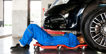 This image shows a man working on the car.